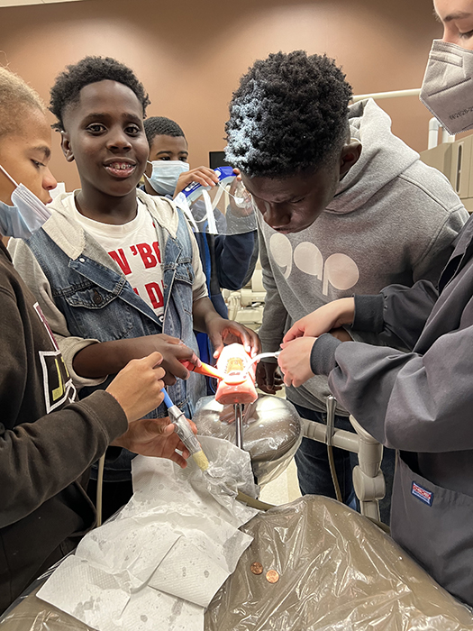 Students participate in a dental assistant training exercise as part of “This Guy Can”, an off shoot of “This Girl Can” that was launched after the original program.